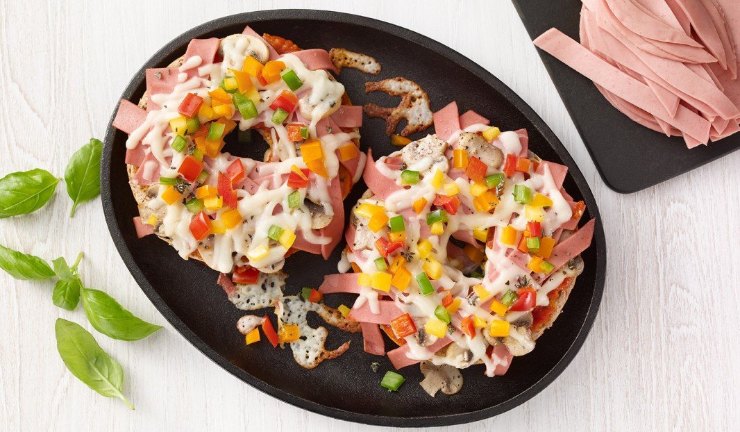 Pizza bagel with bologna, mushrooms and peppers